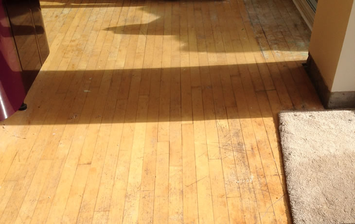 A wood strip floor prior to sanding